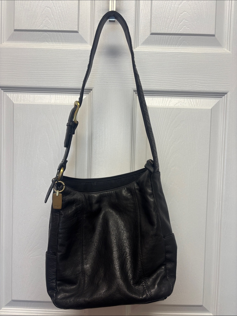 Rolfs Black Leather Shoulder Bag with Brass Accents zip pocket in the back.